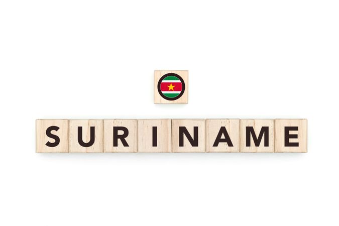 Wooden blocks bearing the name and flag of Suriname. Surinamese and South American Culture, national identity, travel, and geography in a copy space design.geography in a copy space design.