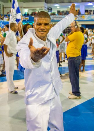 Rio de Janeiro, Brazil - February 13 2014: Smiling dancer offering hand to camera