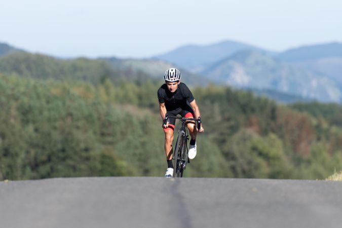 Professional cyclist riding bike in park