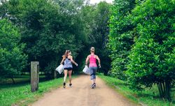 Two women on back doing plogging