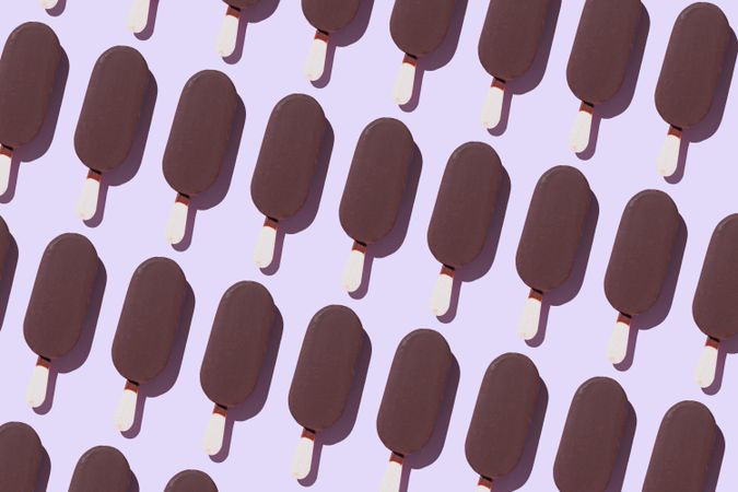 Chocolate popsicles on lavender background