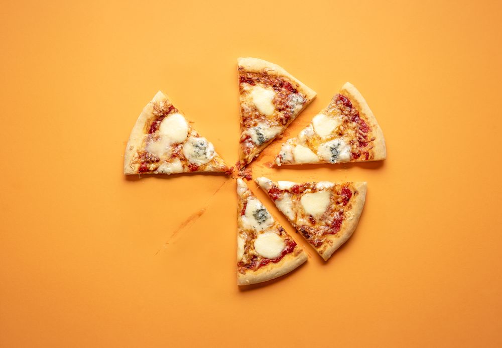 Slightly eaten plain pizza with 4 types of cheese
