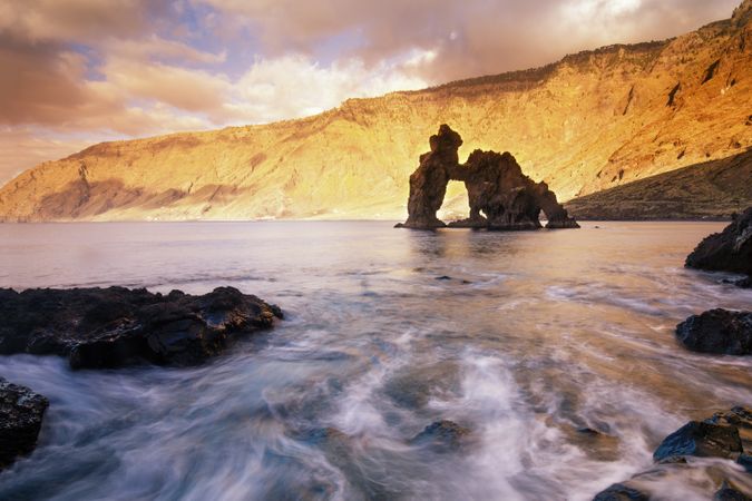 Amazing stone shore and pink sky with clouds