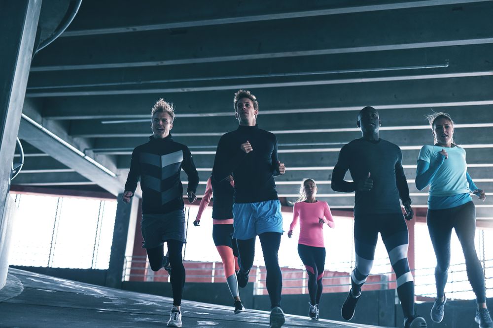 Group of runners jogging down a decline