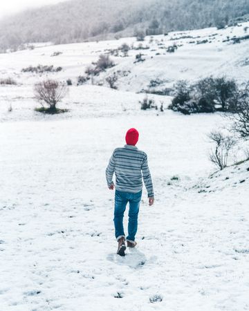 Man walking on winter field