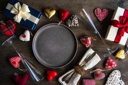 Table setting with scattered presents and heart decorations