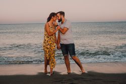 Loving couple embracing happily on sandy beach
