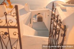 Magic hour shot of stairs in Santorini leading down to the sea 4BDnk0