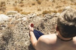 A man meditates, while using the Padmasana pose, during a yoga session in nature