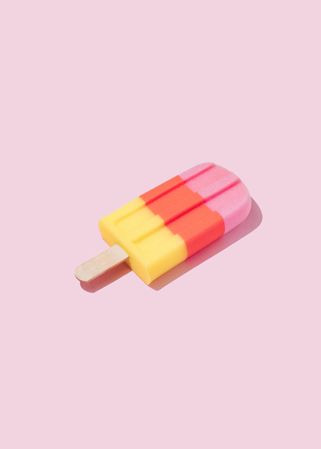 Colorful ice cream popsicle on pastel pink background