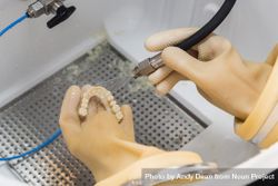 Dental Technician Cleans 3D Printed Dental Implant Bridge bGRnBa