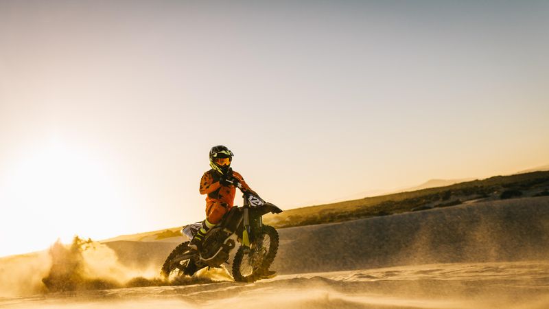 Rider riding dirt bike in the sand