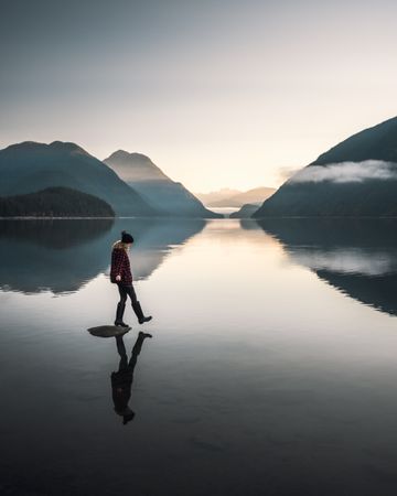 Woman standing on rock near lake