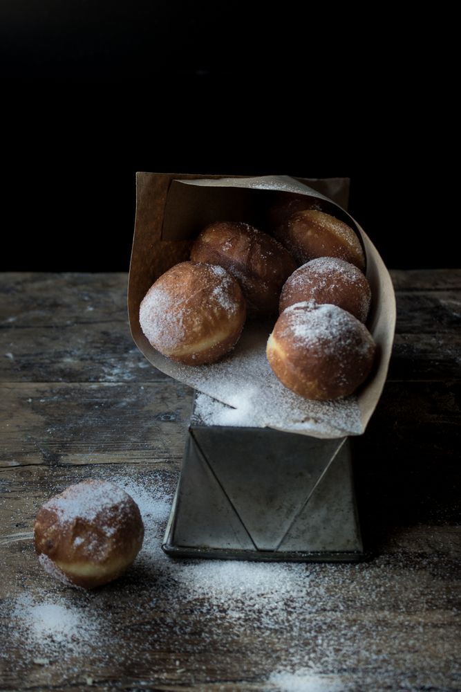 Baked cakes in craft paper on table