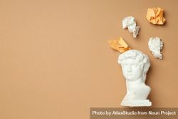 Marble bust with crumpled paper coming out of brain on brown background, copy space 5nGZl4