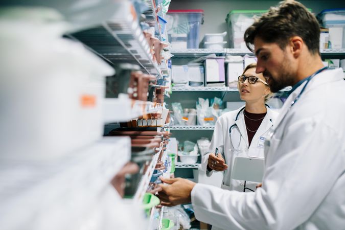 Two pharmacist working in drugstore