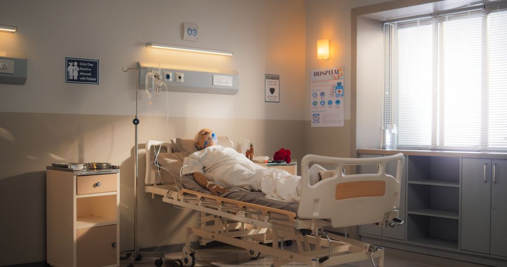 Bright Hospital Ward: Portrait of Indian Older Man Wearing Oxygen Mask Sleeping in Bed, Recovering after Sickness