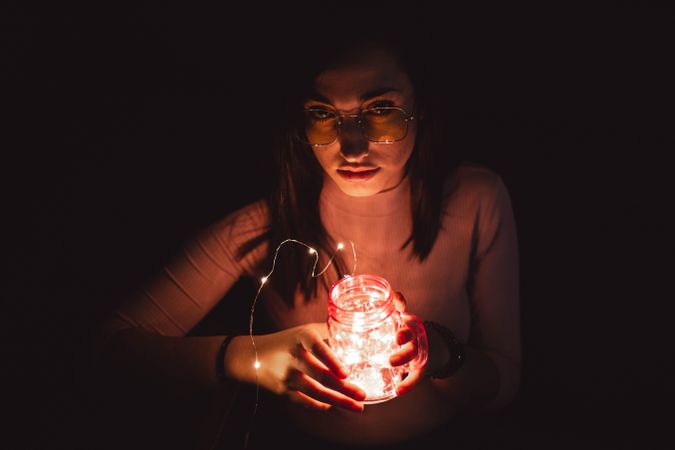 Woman in sunglasses with lamp
