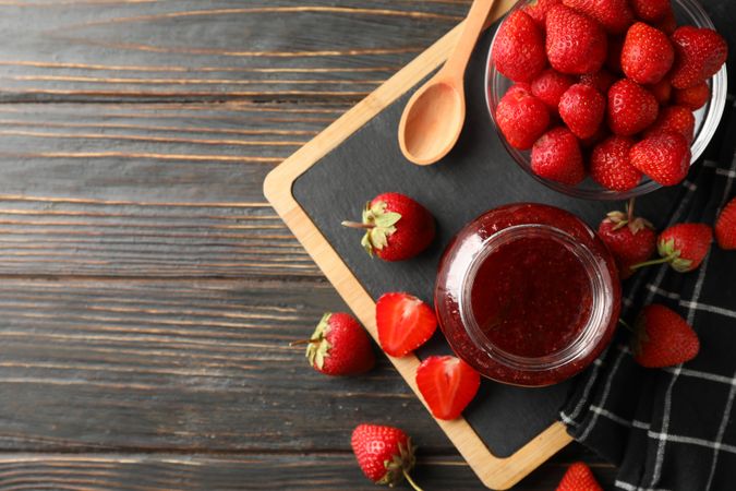 Composition with strawberry jam on wooden background, top view