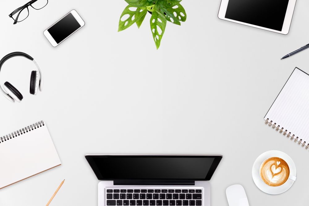 Modern workspace with laptop tablet, smartphone and coffee cup copy space on color background