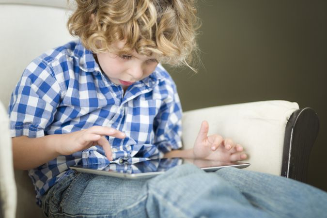 Blond Boy Using His Computer Tablet