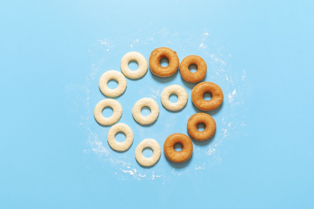 Homemade dough and deep-fried donuts, top view