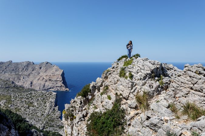 Young woman standing on cliff