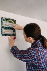 Electrician working on the distribution panel of a house