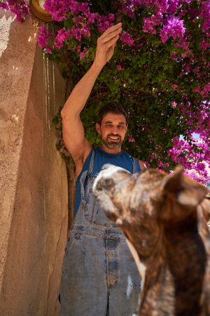 Happy man teasing dog with treat