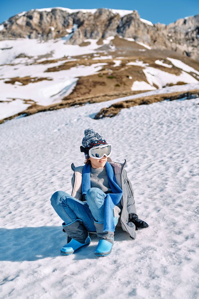 Boy on snowy hill in ski sunglasses