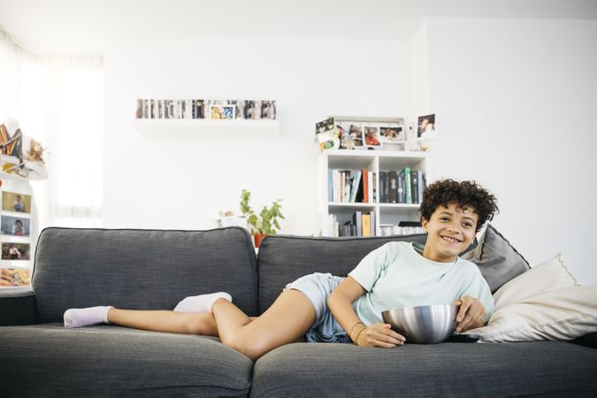 Girl watching tv in living room