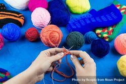 Woman knitting near colorful thread balls 5odog4