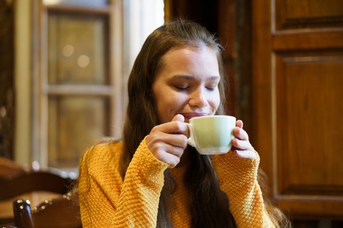 Savoring and relishing a cozy, warm, and relaxing moment with a delightful cup of coffee