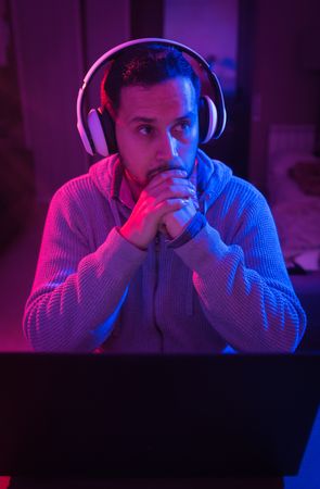 Man listening cheerfully to music with headphones.