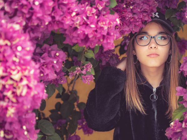 Woman on background of stunning violet flowers