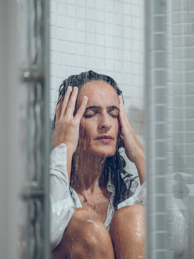 female sitting in shower