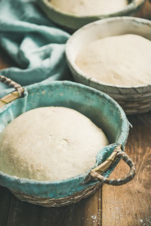 Multiple baskets of bread dough