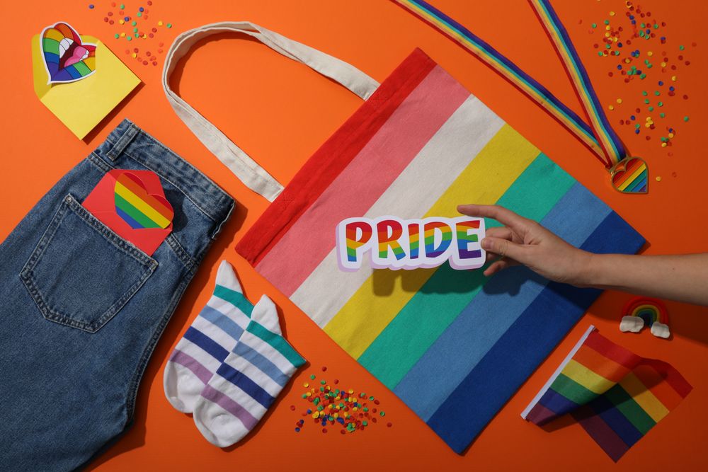 Pride parade concept, symbols on orange background.