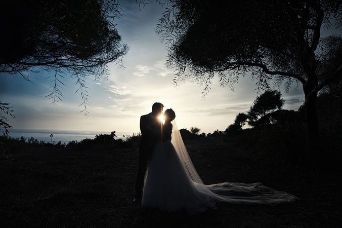 Marriage of woman and man embracing in darkness