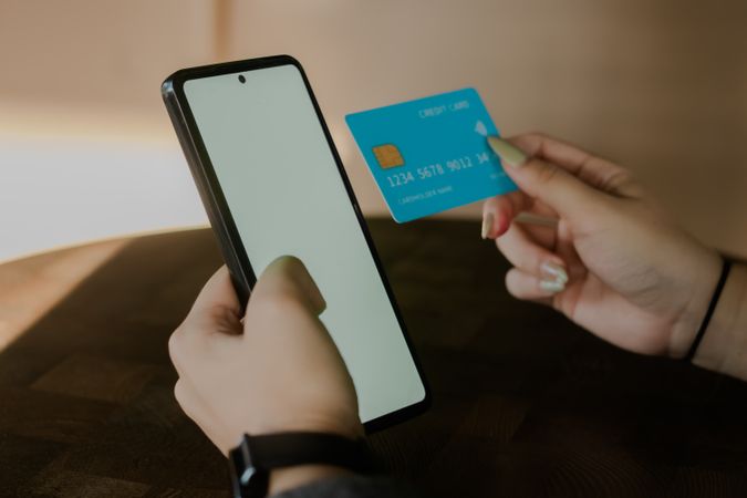 Digital payment on the smartphone with a plastic credit card and phone