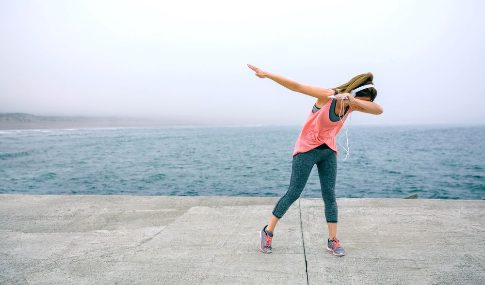 Woman making dab dance outdoors
