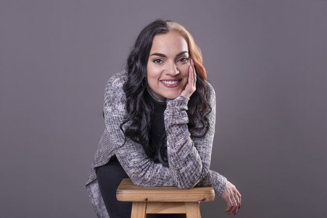woman looking at camera with hands on face.