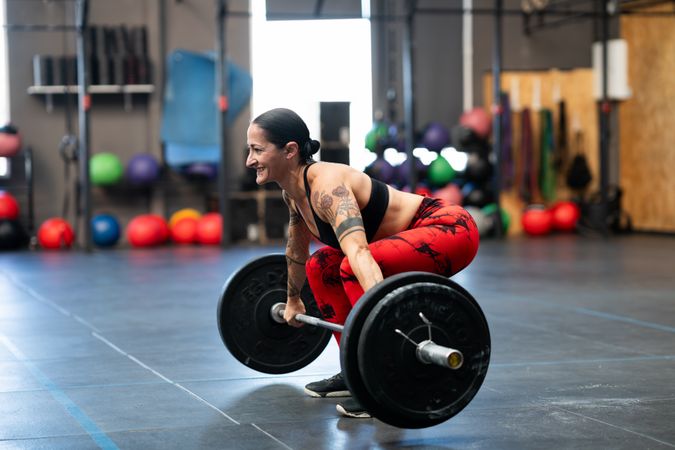 Tattooed fit woman deadlifting