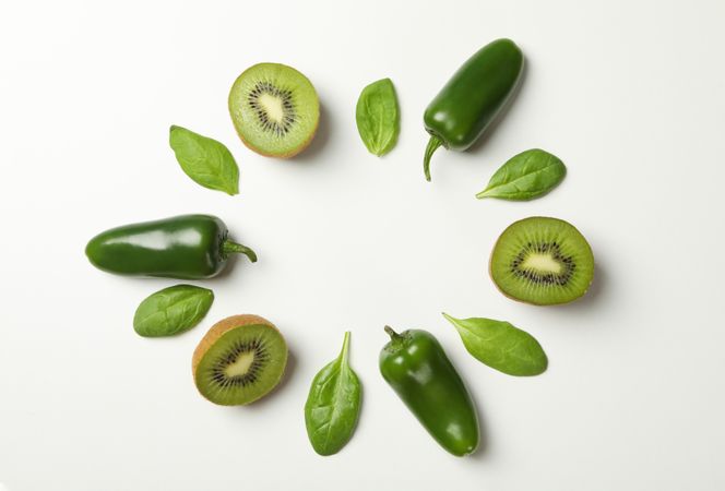 Kiwi, spinach and pepper on blank background