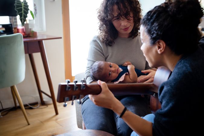 Female playing music for baby and partner