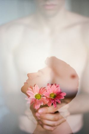 Double exposure of brunette young guy and bouquet of fresh rose blooms on blurred background