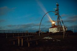 Road and lighthouse in evening