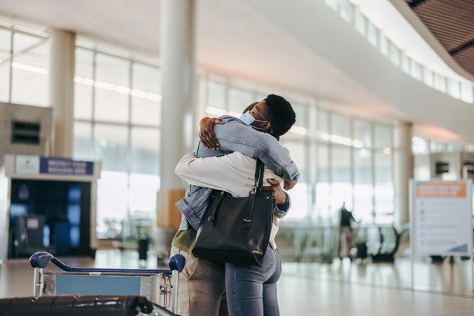 Couple embracing each other before departing at airport