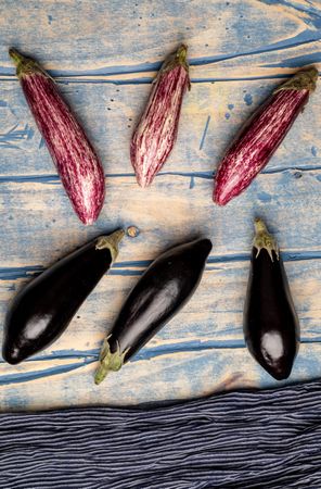 Ripe eggplants on shabby tabletop