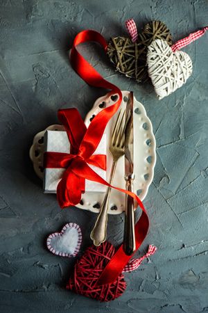 St. Valentine day table setting with heart plate and decorations